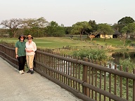 Sarah and Pene on the dam wall, chalets 64 and 63 in the background